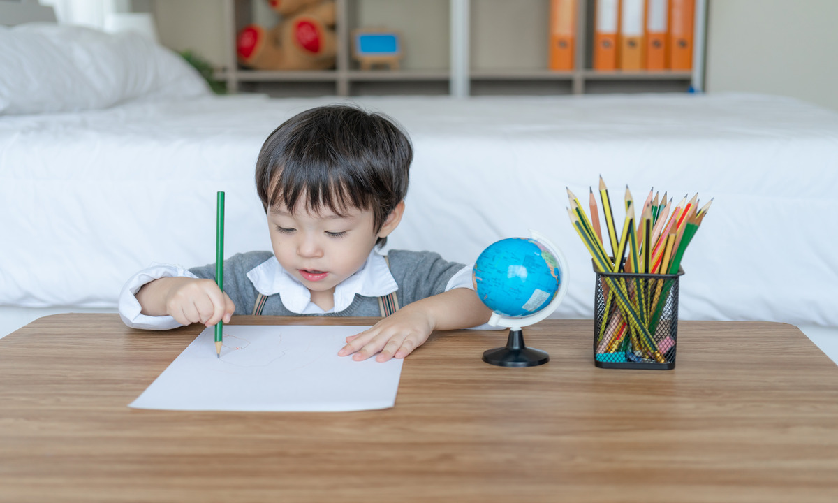 little boy joyful with use pencil color drawing white paper 1